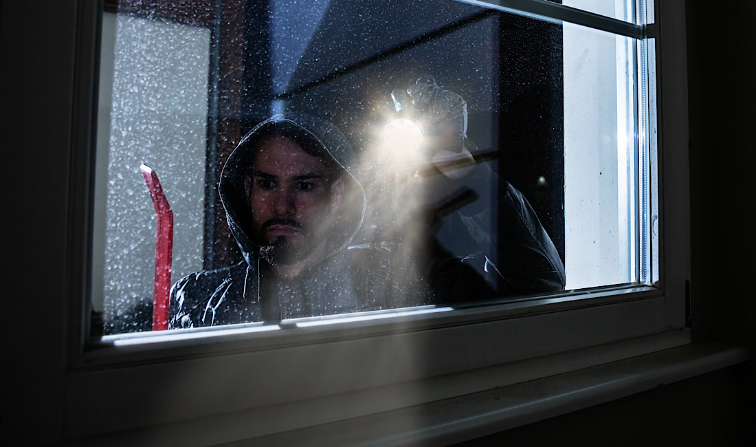 Burglar looking into a house window in Meridian, ID