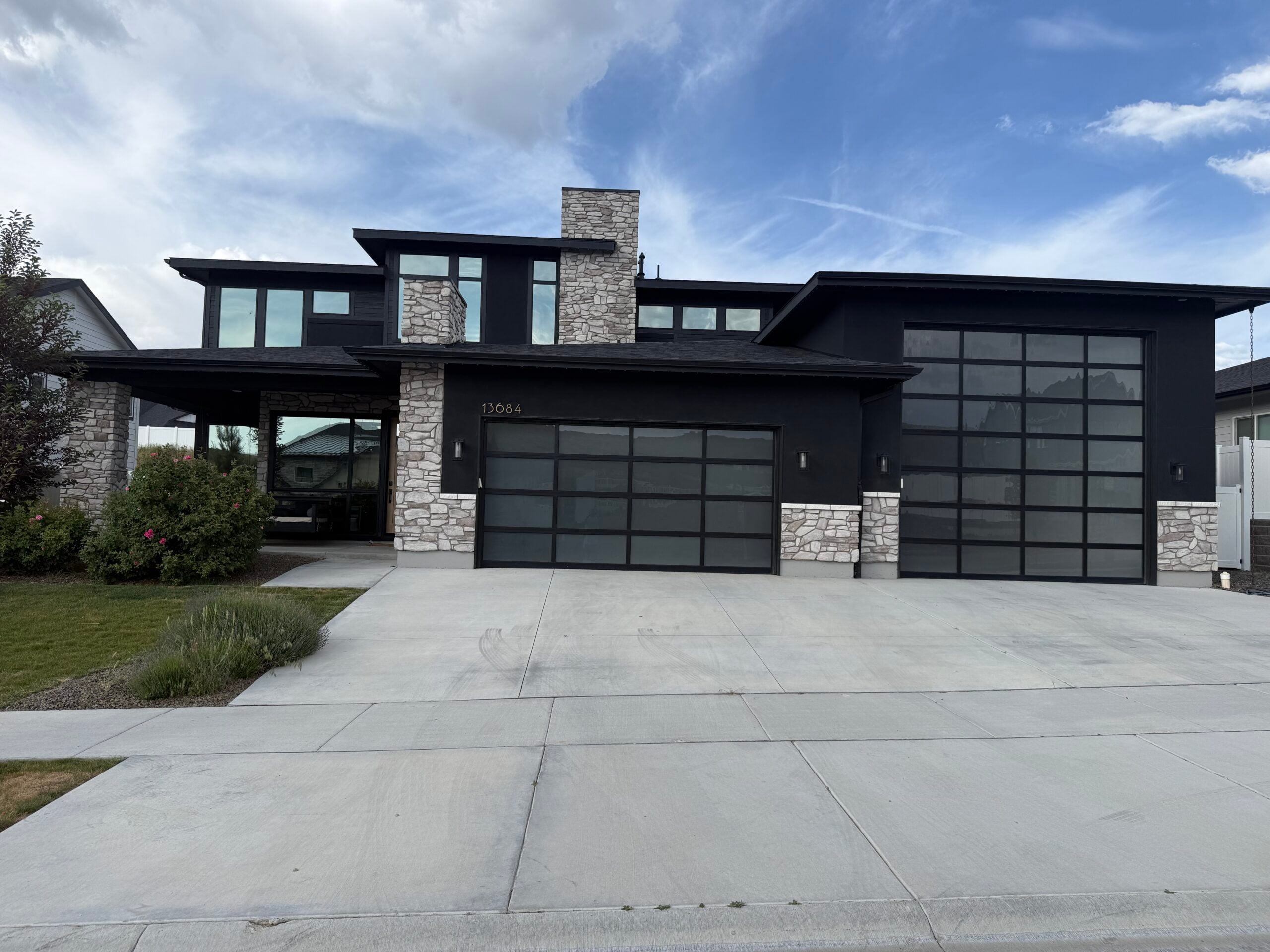 Residential window tinting on modern home with large black-framed windows in Idaho